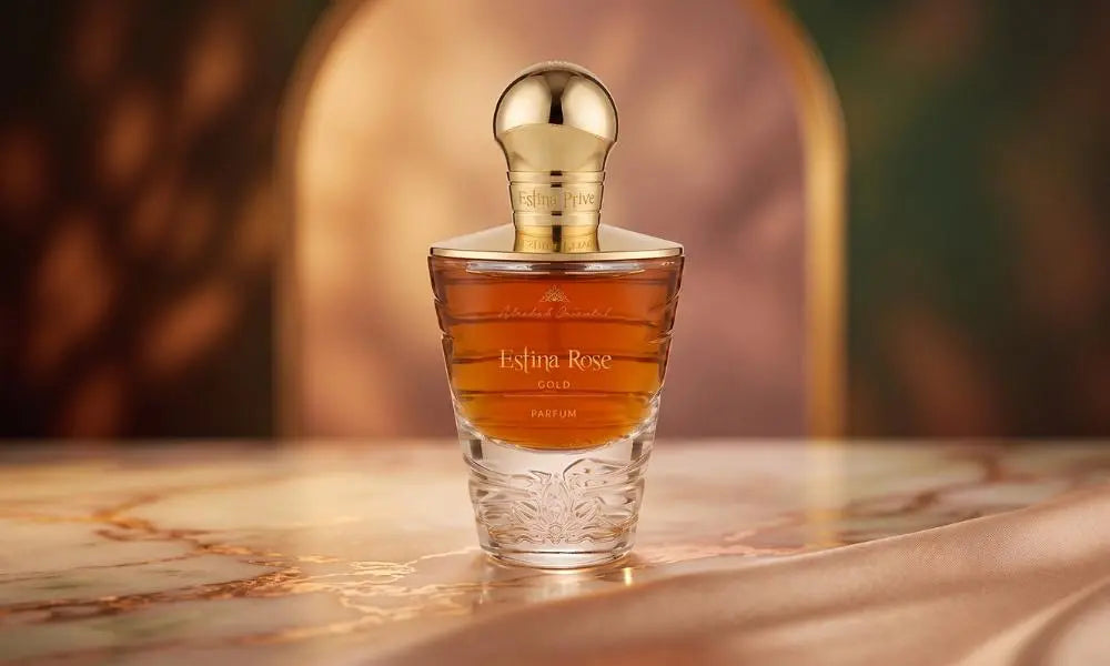 A beautiful flat lay of the perfume bottle surrounded by its natural ingredients like rose petals, vanilla, and jasmine.