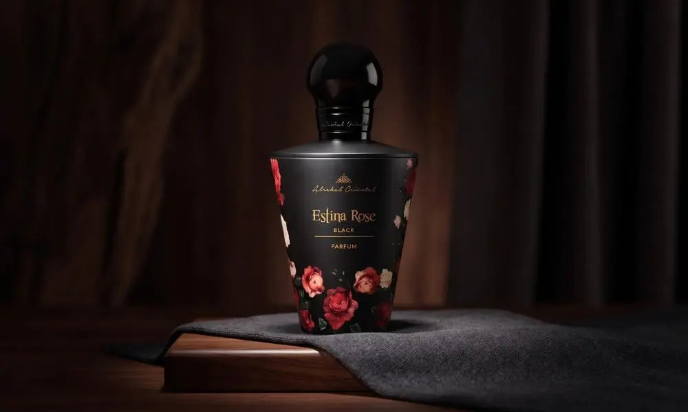 Elegant black Estina Rose perfume bottle on wood and fabric, luxury dark background
