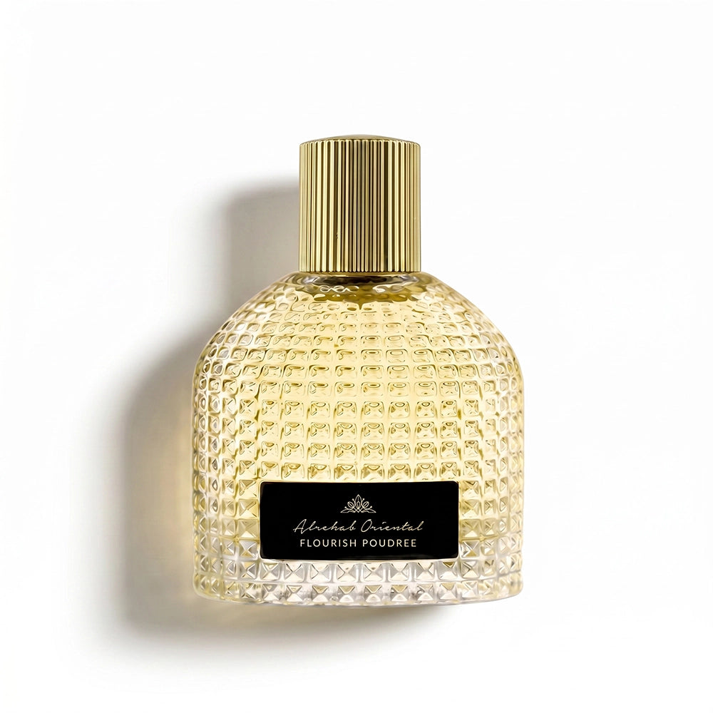 A textured glass perfume bottle filled with pale gold liquid, featuring a ribbed gold cap and a black label with white text reading 'Alcohol Free FLOUR POWDER'. The bottle is photographed on a clean white background with a soft shadow to the left.