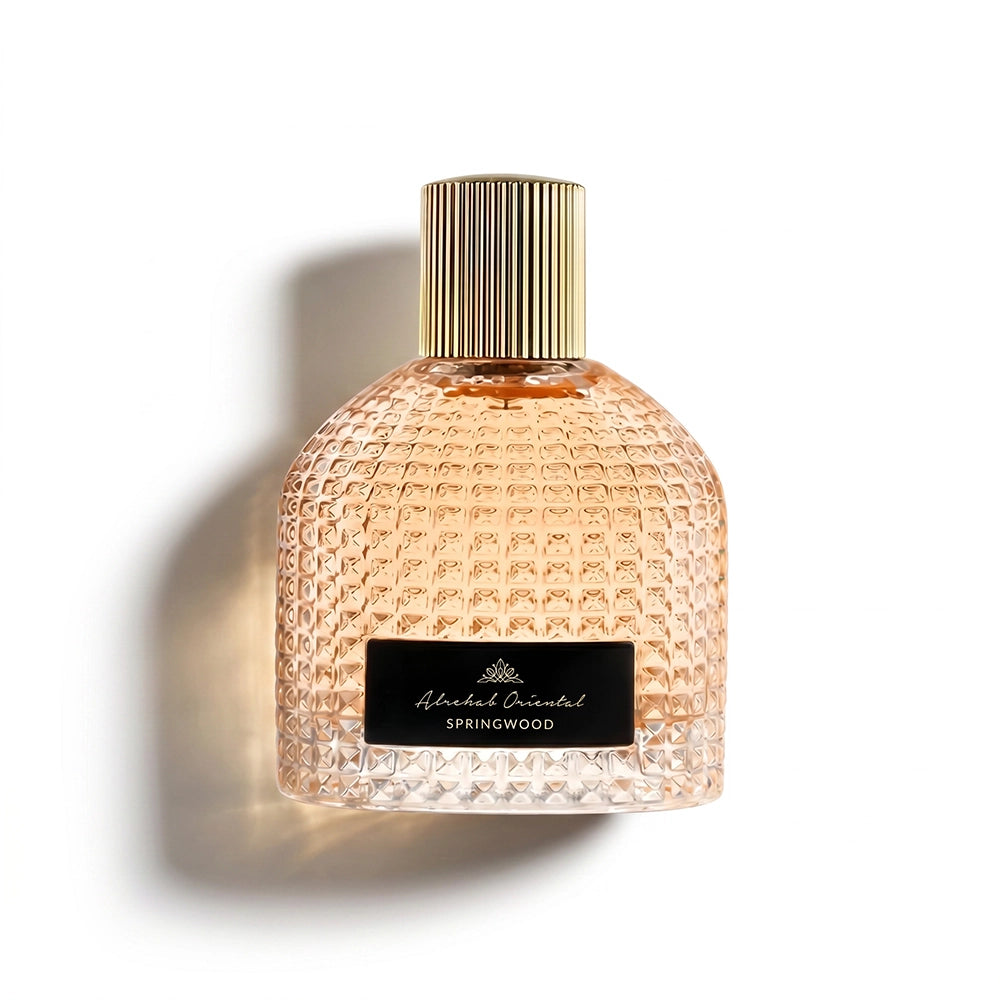 A luxurious textured glass bottle of SPRING WOOD PARFUM by Alrehab Oriental, featuring a ribbed gold cap and a black label against a clean white background.