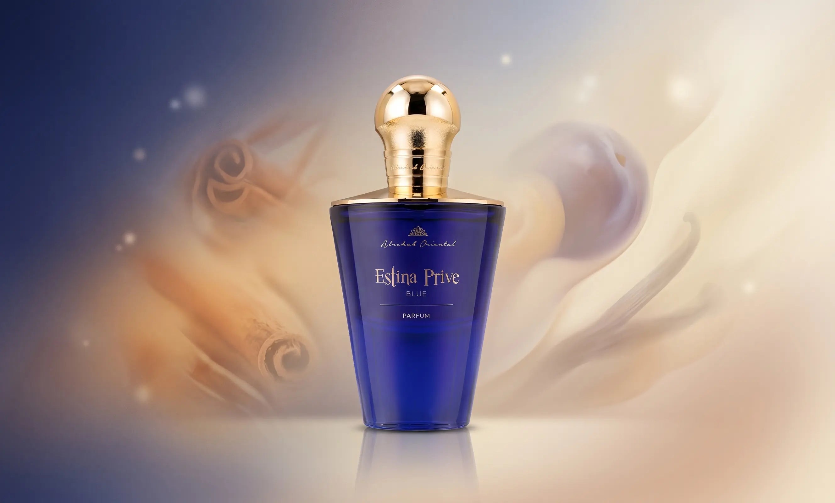 Centered Estina Prive Blue perfume bottle with gold cap, set against a blurred background of cinnamon and berries.