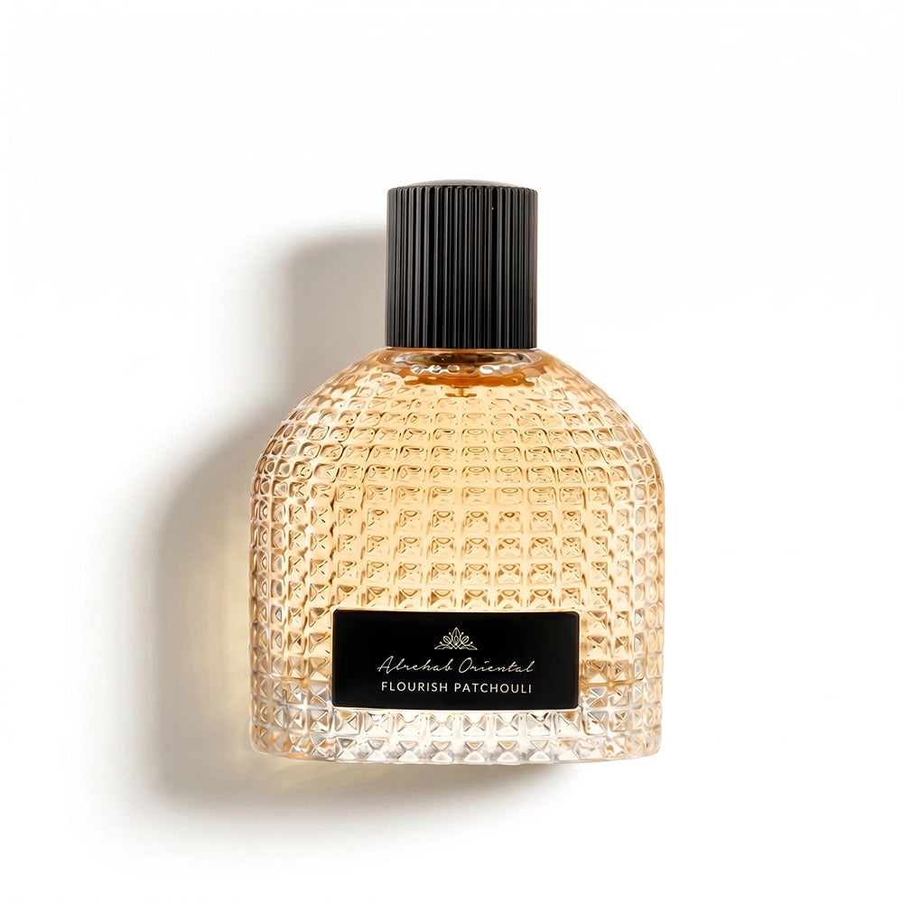 A textured glass perfume bottle with a black ribbed cap and a black label reading 'Aldrian Parfum FLOURISH PATCHOULI', photographed on a clean white background with a soft shadow.