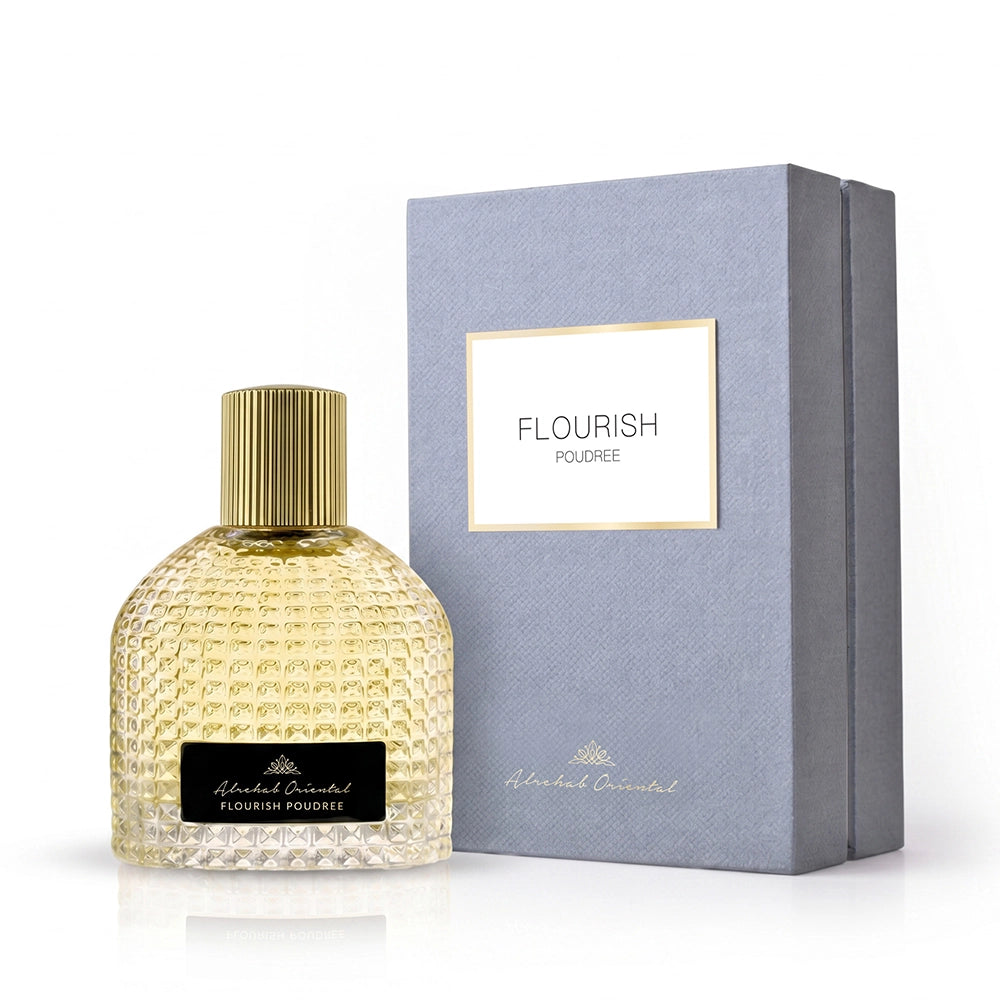 A bottle of Alakhanch Oriental 'Flourish' Eau de Parfum next to its textured gray-blue presentation box on a white background.