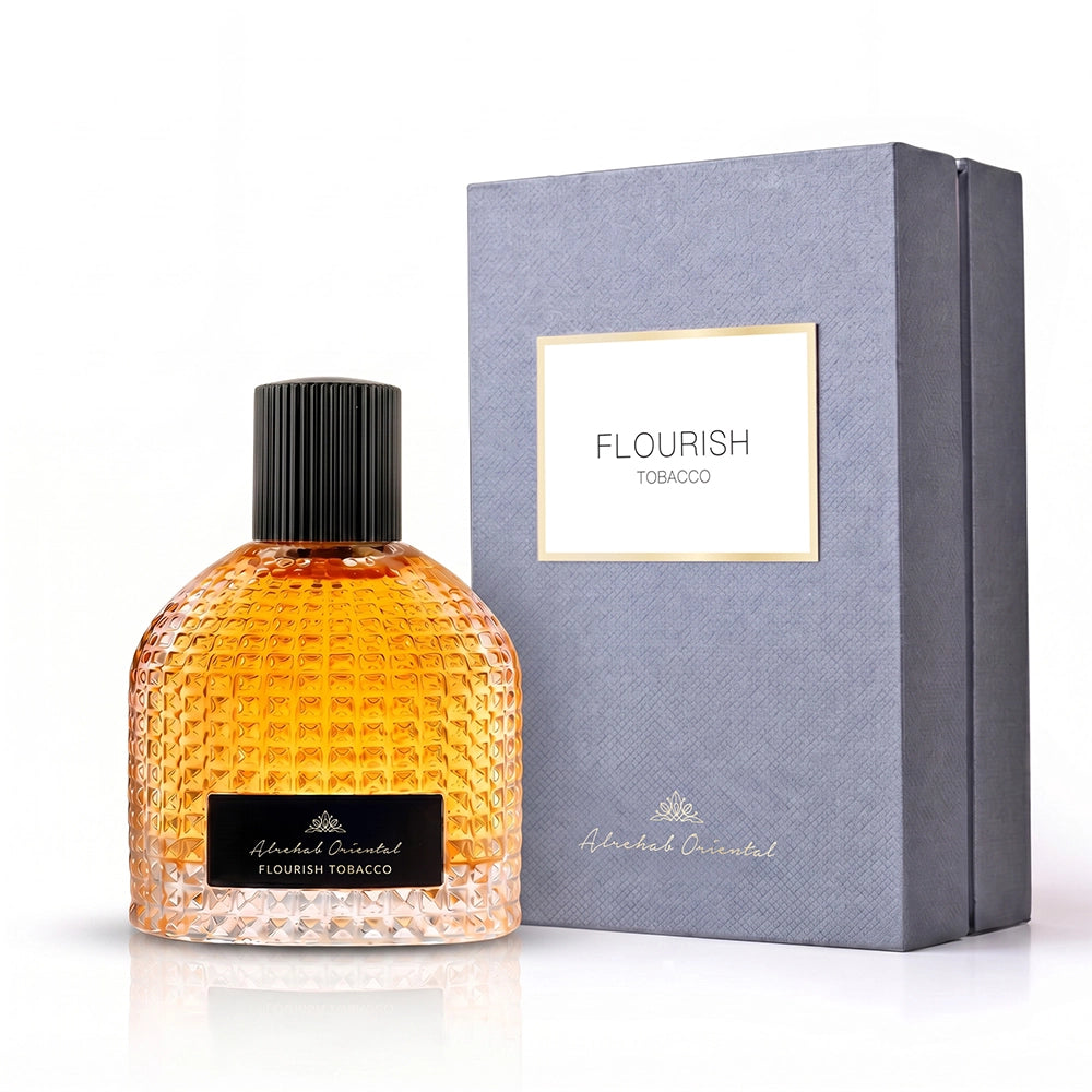 A bottle of Alcohol Oriented Flourish Tobacco next to its textured gray packaging box with a gold-bordered white label.